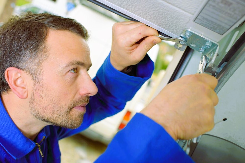 Handyman repairing a garage door