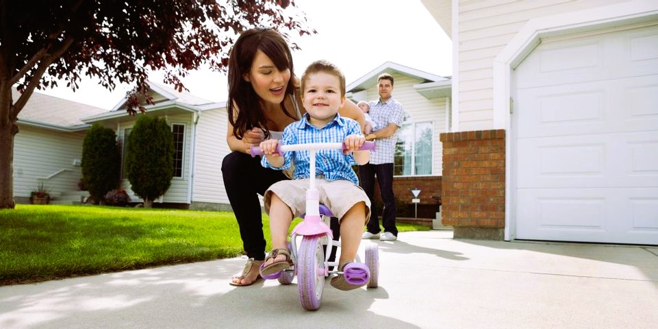 Family in front of a house with a garage